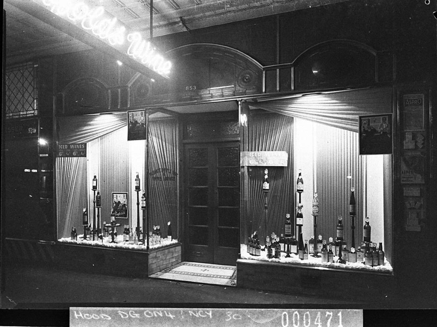 A lit Penfolds Wines shop window display at night, Sydney, 1939
